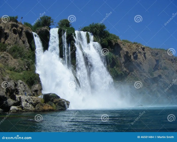 Waterfall sea flowing high into stock lake